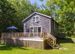 The cottage enjoys a large deck overlooking the yard and Penobscot Bay